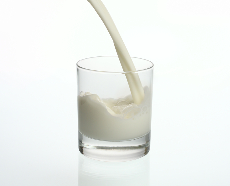 Over white. Little Milk in a Glass. Milk in the Middle.